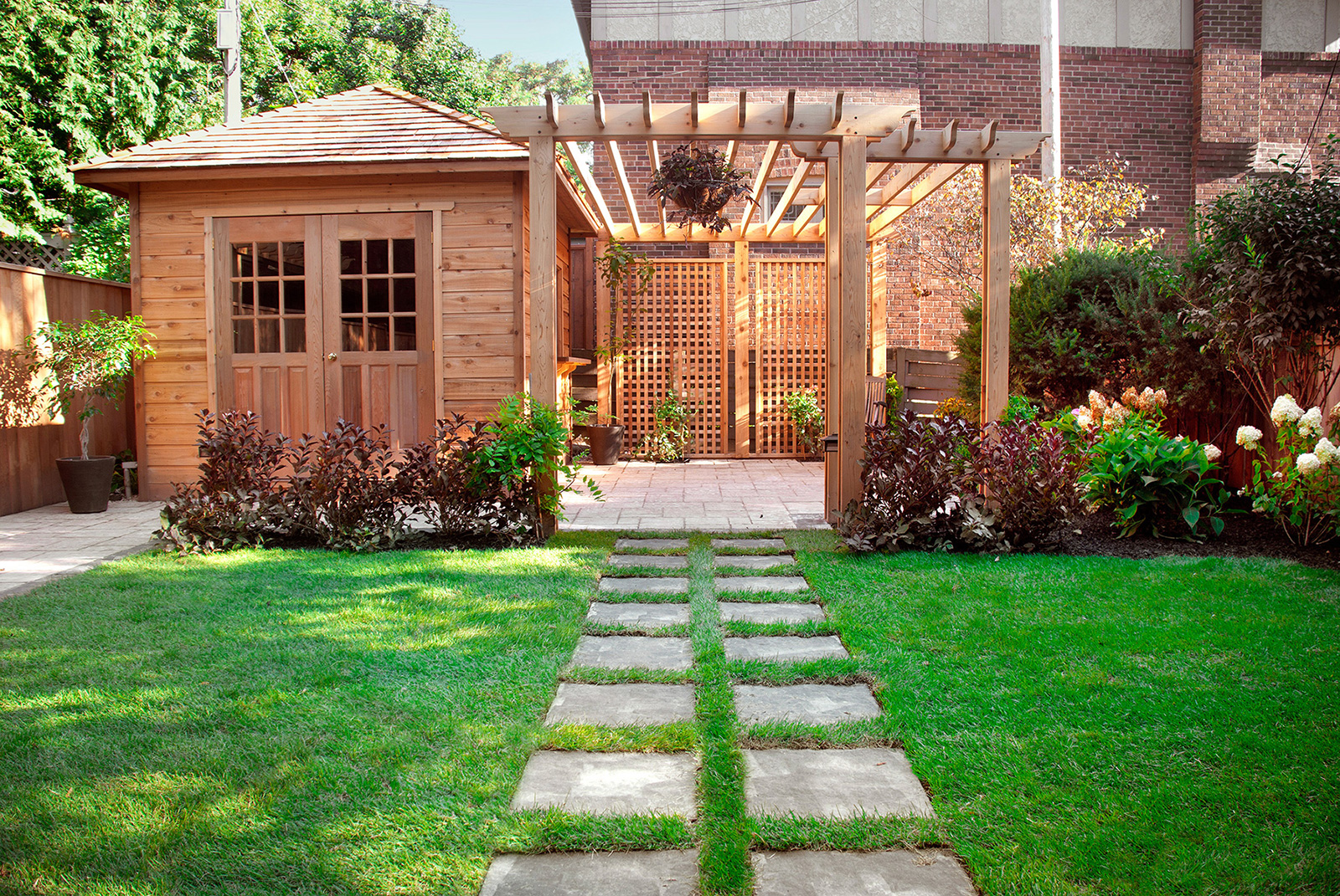 cedar shed in green garden